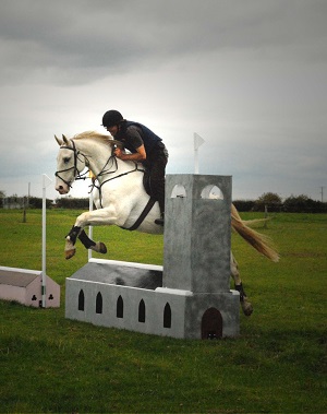Milky jumping the church at a Bassingfield cross country event